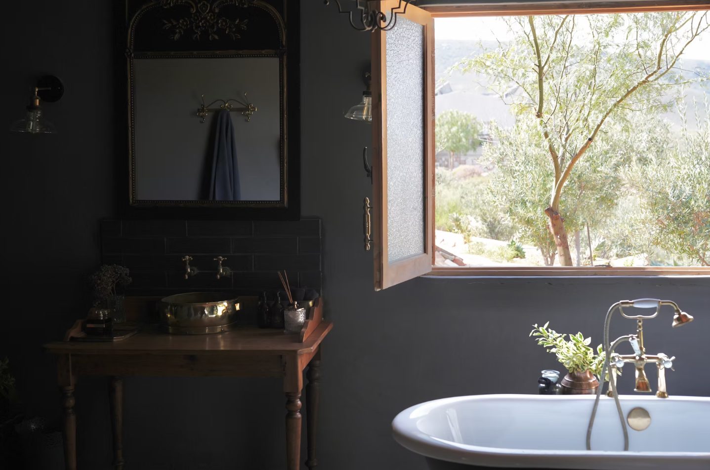 Free-standing bath beside an open window at Doringbos