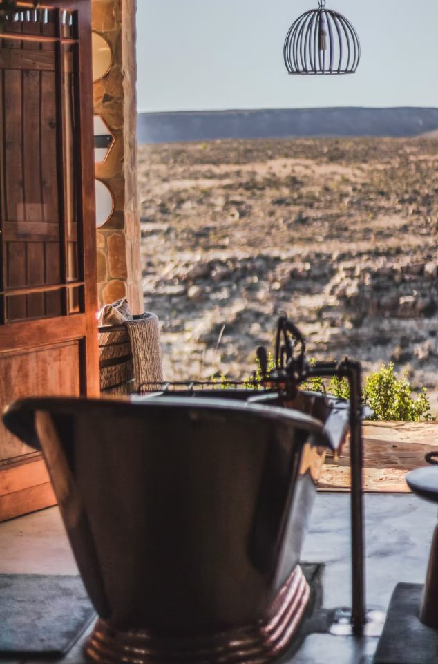 Freestanding bath and desert view inside one of the cottages at Doringbos